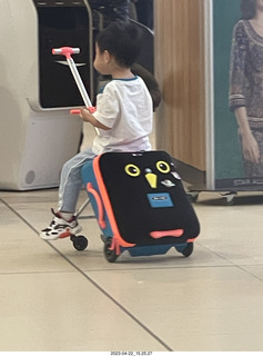 15 a1s. kid with cool riding toy from a suitcase