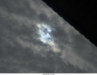 54 a24. Torreon eclipse day - partial eclipse through clouds, attempt by iPhone