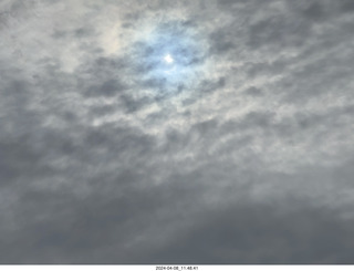 61 a24. Torreon eclipse day - partial eclipse through clouds, attempt by iPhone