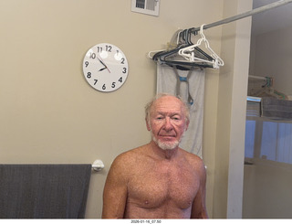 Adam shirtless with my new bathroom mirror clock